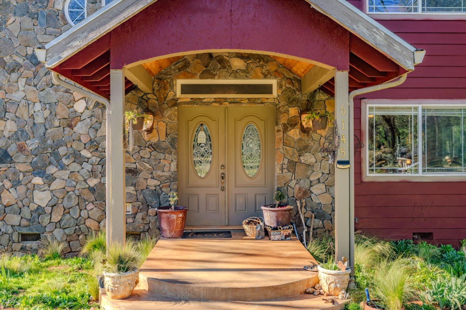 6145 Swiss Ranch Road Mountain Ranch, CA 95246 - Photo 9 of 84 a front view of a house with a garden