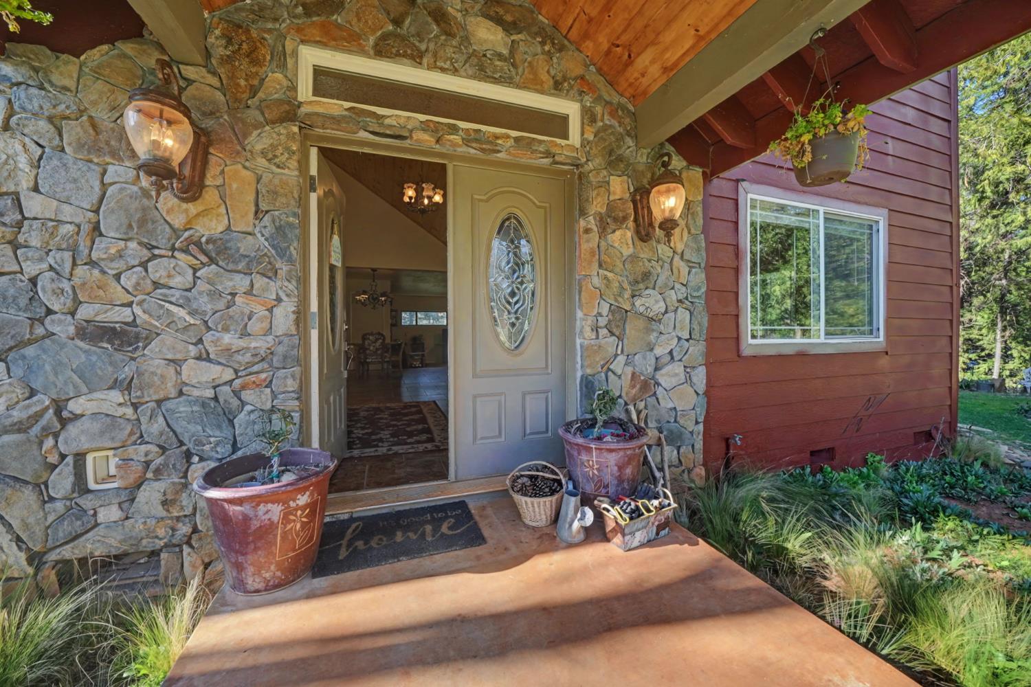 6145 Swiss Ranch Road Mountain Ranch, CA 95246 - Photo 10 of 84 a front view of a house with outdoor seating and plants