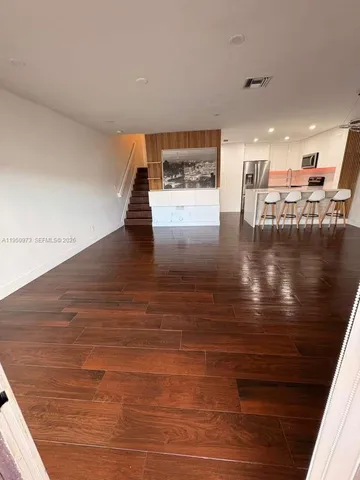a view of a living room with hardwood floor