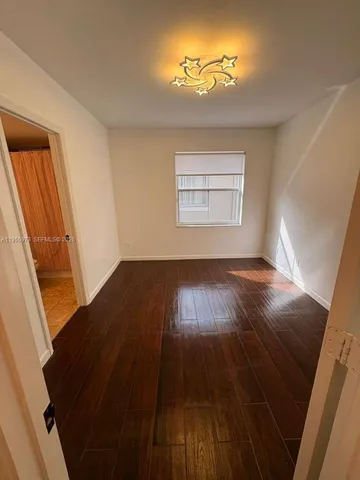 a view of a room with wooden floor and staircase