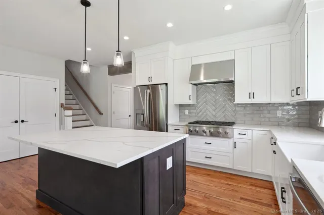 a kitchen with a sink a refrigerator and a stove