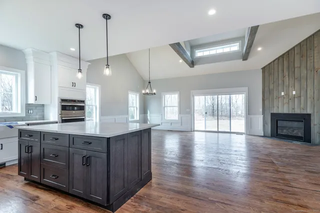a kitchen with stainless steel appliances granite countertop wooden floors sink and cabinets