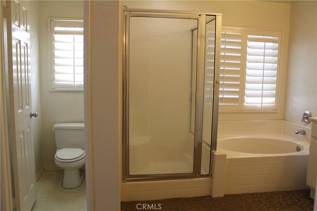 7881 Margaux Place Rancho Cucamonga, CA 91739 - Photo 17 of 41 a bathroom with a bathtub and a shower