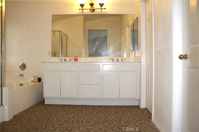 a bathroom with a sink a vanity and a mirror