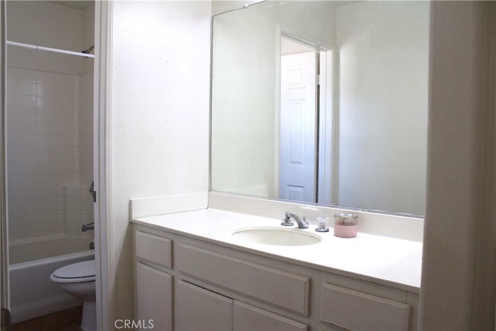 7881 Margaux Place Rancho Cucamonga, CA 91739 - Photo 24 of 41 a bathroom with a sink a toilet a mirror and shower