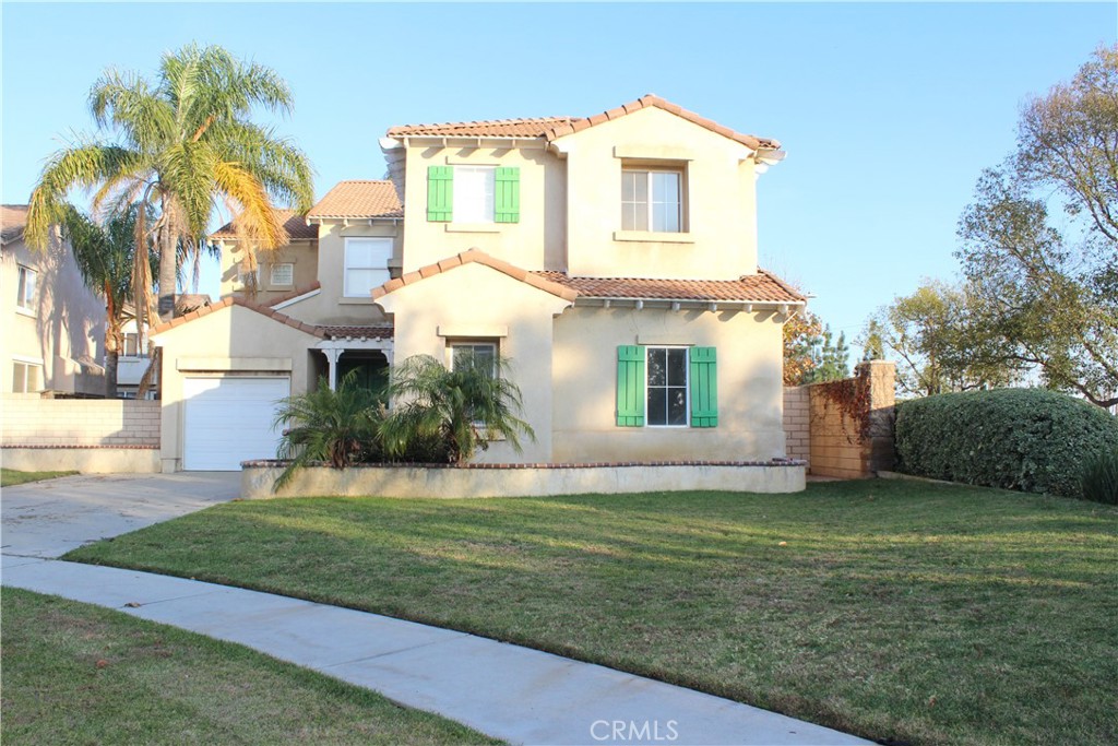 7881 Margaux Place Rancho Cucamonga, CA 91739 - Photo 41 of 41 a front view of a house with a yard and garage