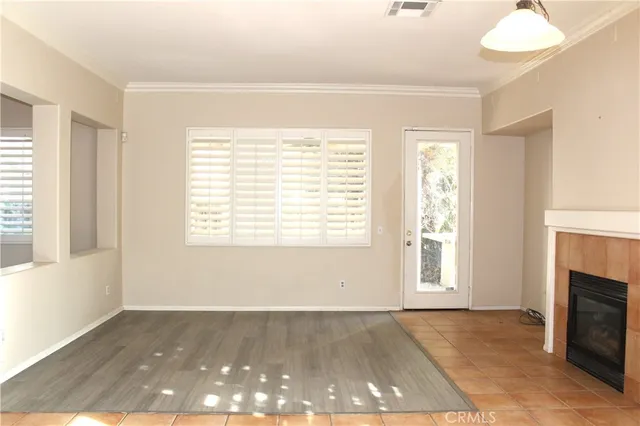 a view of empty room with a fireplace and window