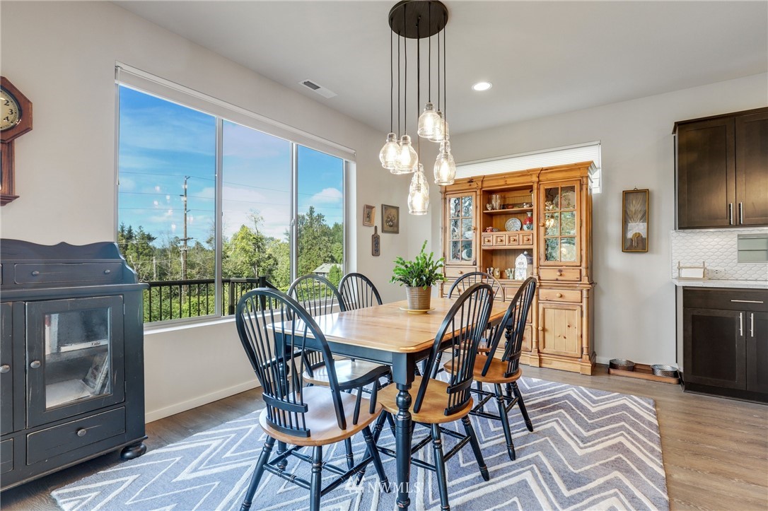 19237 97th Avenue South Renton, WA 98055 - Photo 14 of 29 a view of a dining room with furniture window and wooden floor