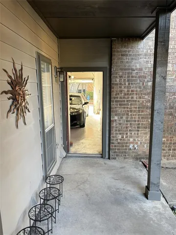 a room with water heater and wooden cabinets