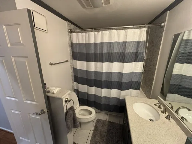 a bedroom with a bed and a flat tv screen