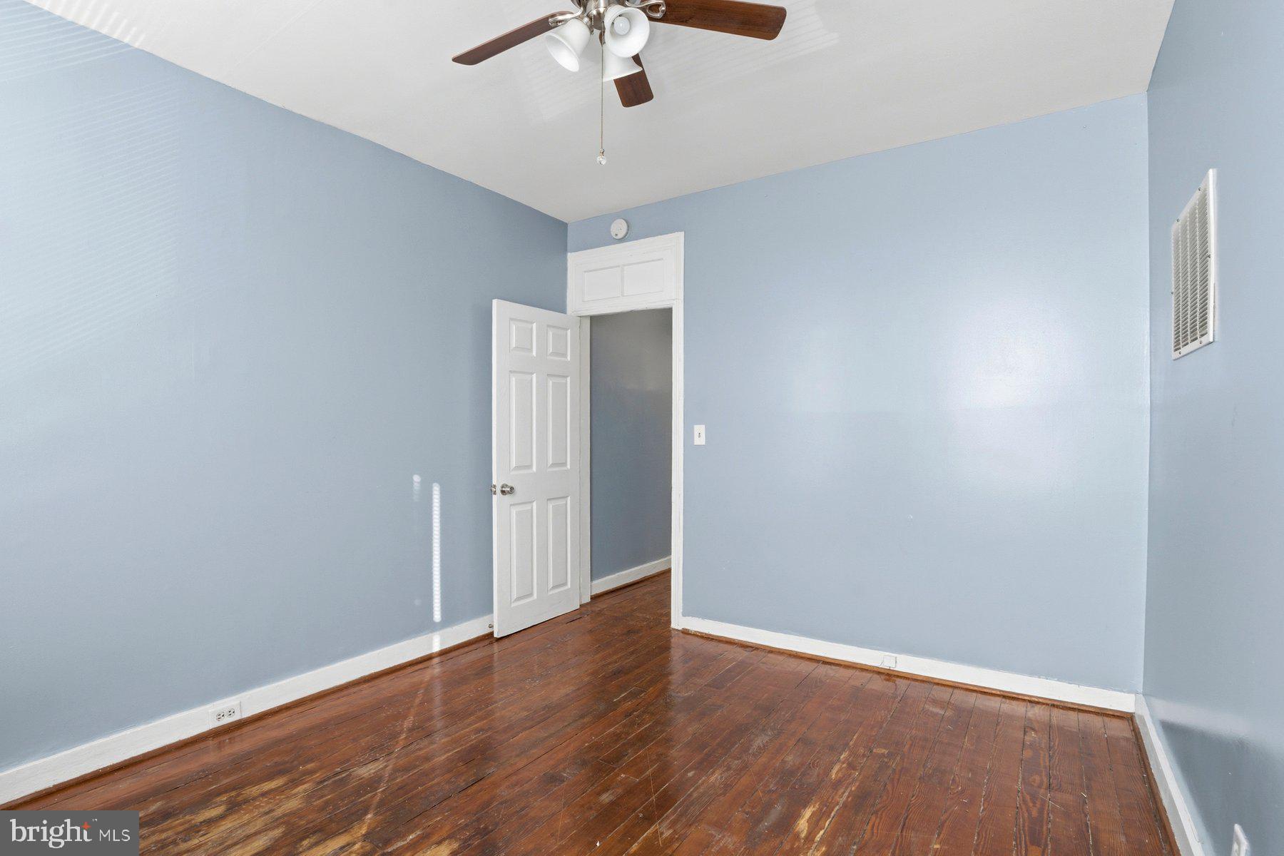 12 West Randall Street Baltimore, MD 21230 - Photo 19 of 28 wooden floor in an empty room with a window