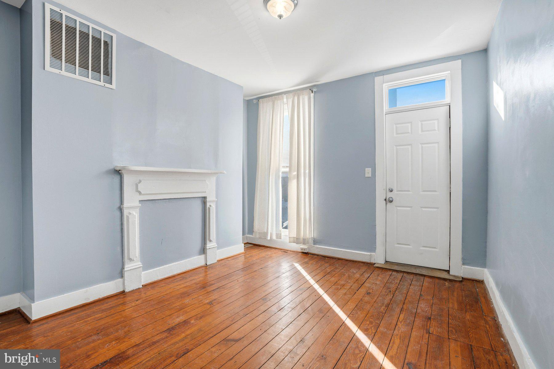 12 West Randall Street Baltimore, MD 21230 - Photo 7 of 28 a view of an empty room with wooden floor and a window
