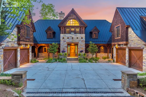a living room with furniture a large window and a fireplace