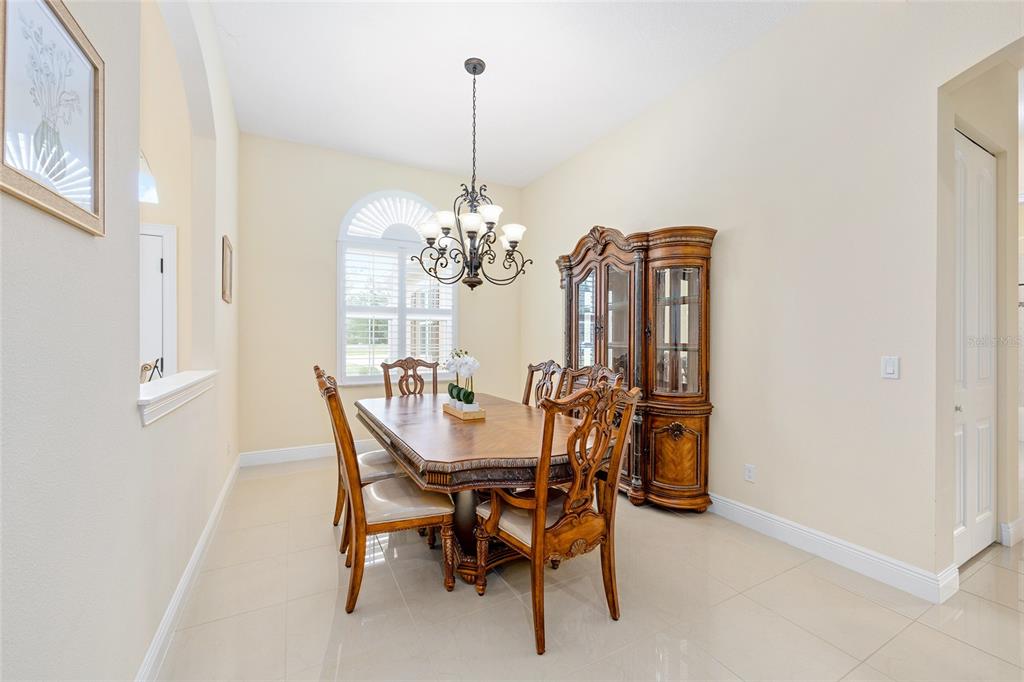 5024 Southwest 114th Street Road Ocala, FL 34476 - Photo 11 of 56 a view of a dining room with furniture and chandelier
