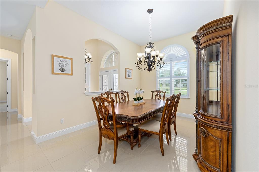 5024 Southwest 114th Street Road Ocala, FL 34476 - Photo 12 of 56 a view of a dining room with furniture and chandelier