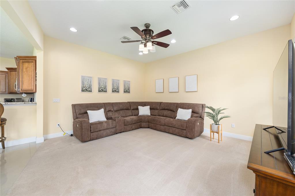 5024 Southwest 114th Street Road Ocala, FL 34476 - Photo 23 of 56 a living room with furniture and a ceiling fan