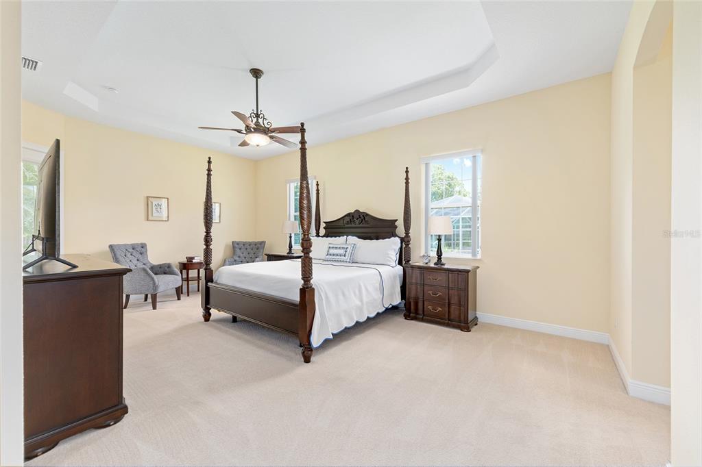 5024 Southwest 114th Street Road Ocala, FL 34476 - Photo 27 of 56 a bedroom with a bed and a chandelier