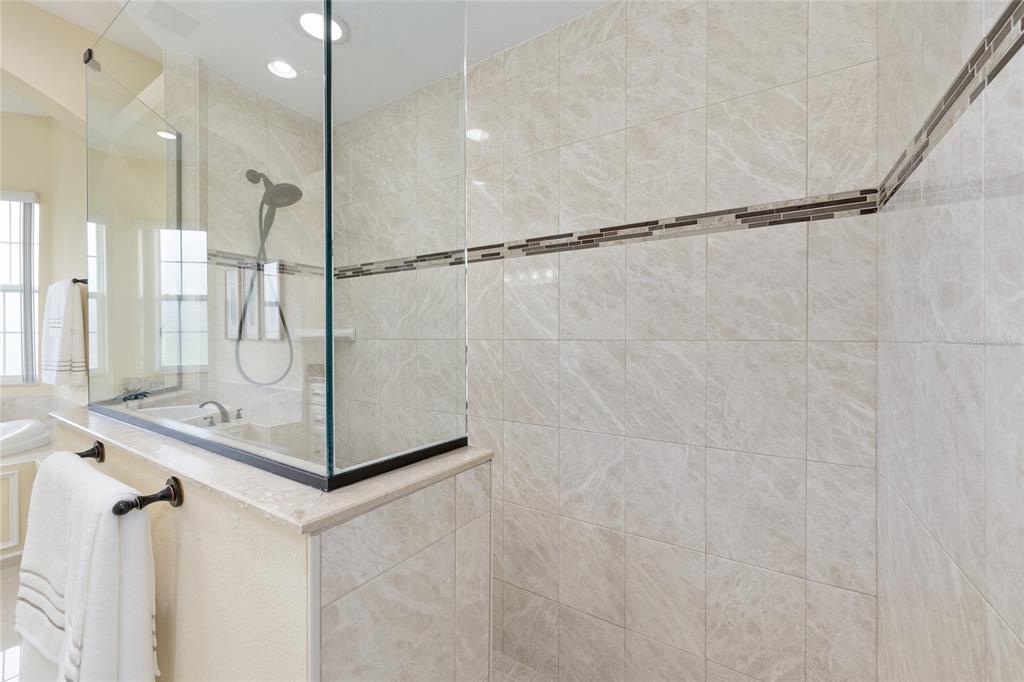 5024 Southwest 114th Street Road Ocala, FL 34476 - Photo 33 of 56 a bathroom with a shower and a glass door