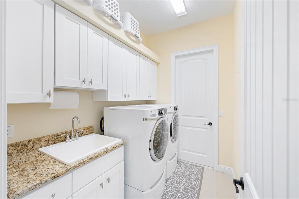 5024 Southwest 114th Street Road Ocala, FL 34476 - Photo 41 of 56 a utility room with sink dryer and washer