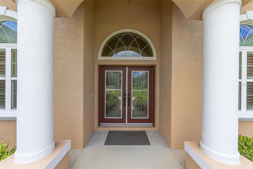 5024 Southwest 114th Street Road Ocala, FL 34476 - Photo 5 of 56 a front view of a house with a yard