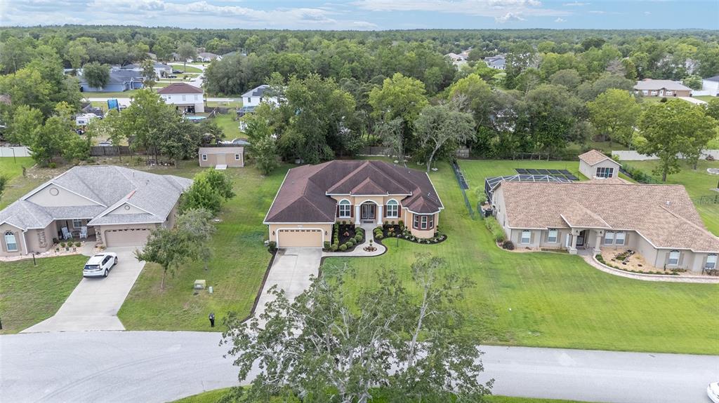 5024 Southwest 114th Street Road Ocala, FL 34476 - Photo 52 of 56 an aerial view of a house with garden space and street view