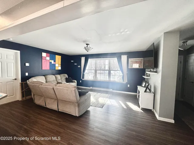 a kitchen with stainless steel appliances granite countertop a table chairs sink and cabinets