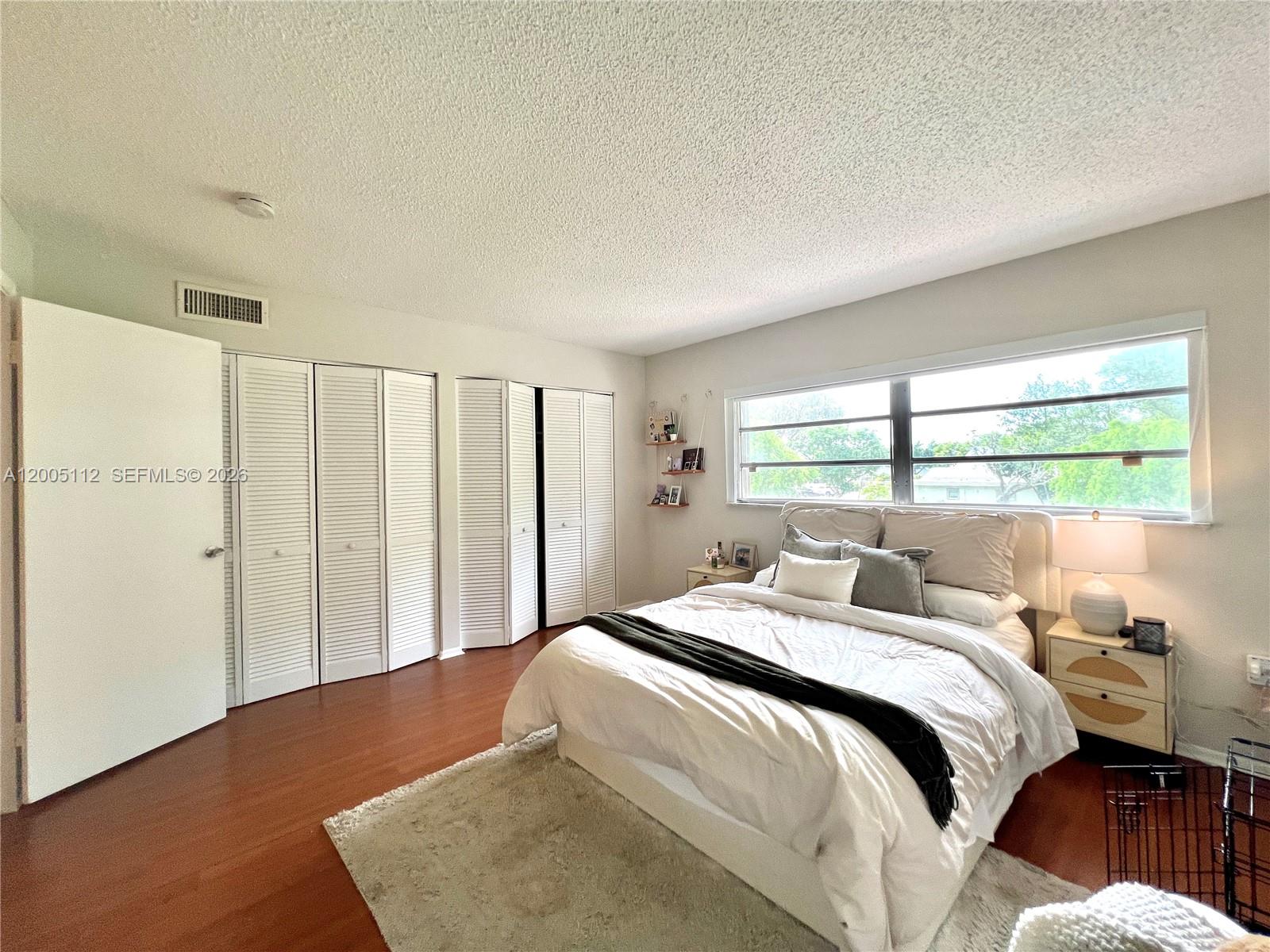8114 Southwest 81st Terrace Miami, FL 33143 - Photo 13 of 20 a bedroom with a bed and a window