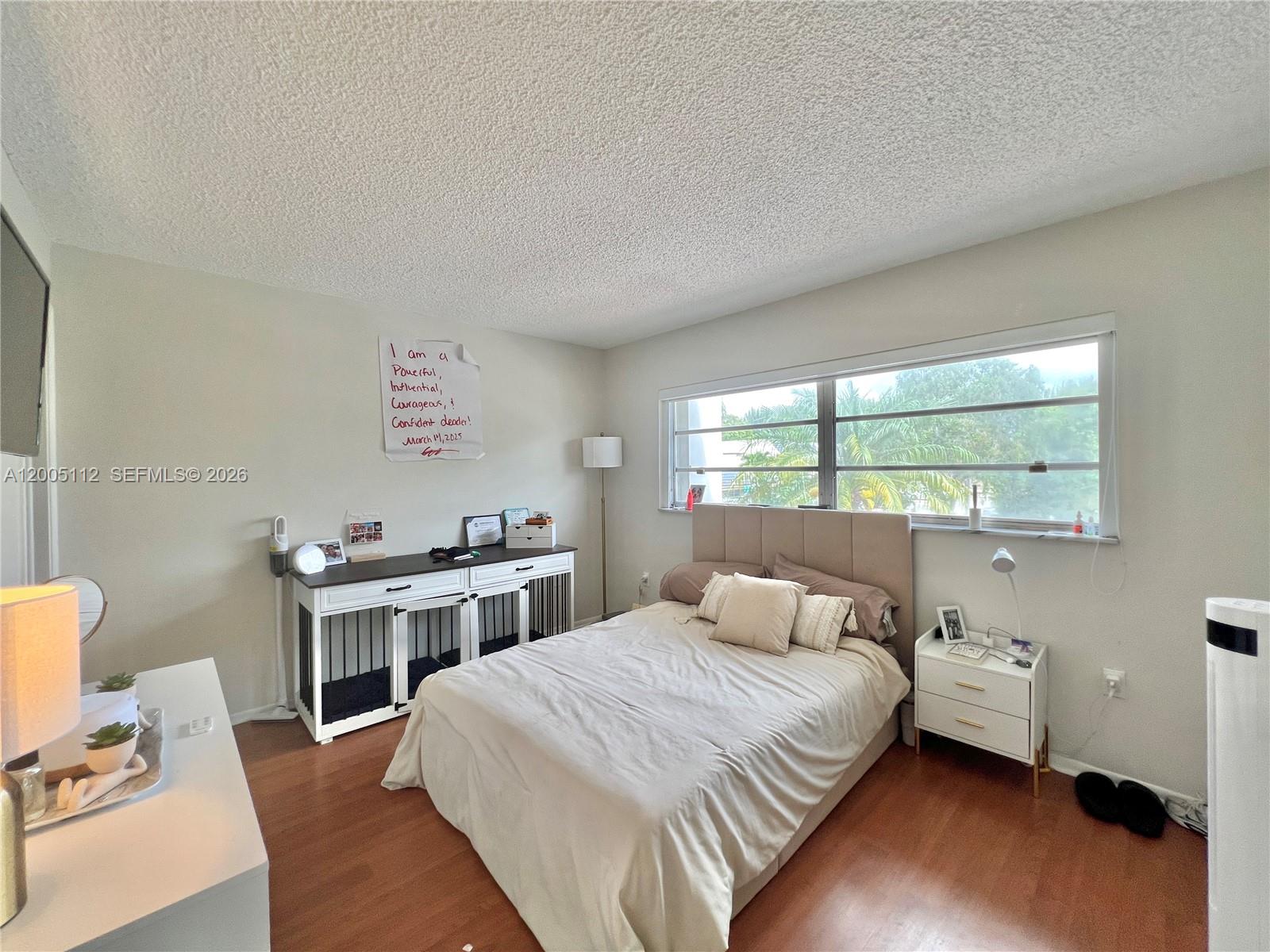8114 Southwest 81st Terrace Miami, FL 33143 - Photo 14 of 20 a bedroom with a bed and a window