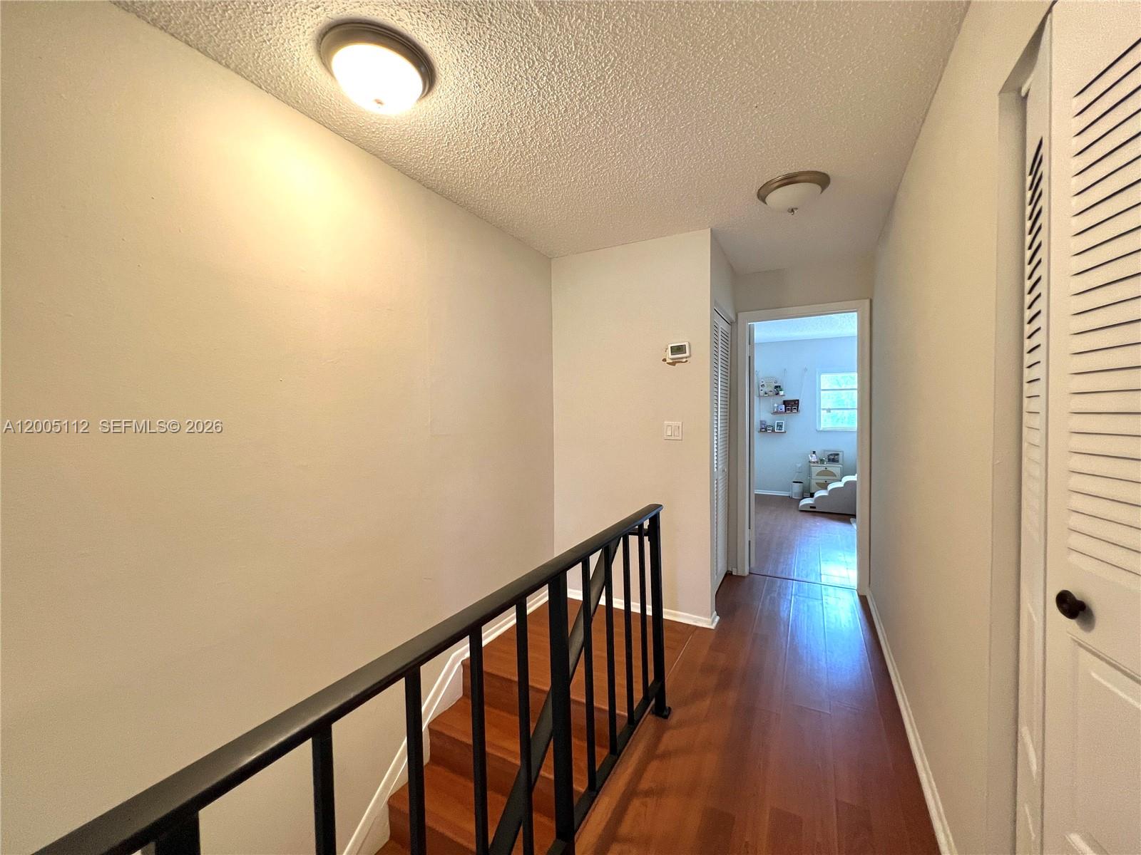 8114 Southwest 81st Terrace Miami, FL 33143 - Photo 16 of 20 a view of a hallway with wooden floor