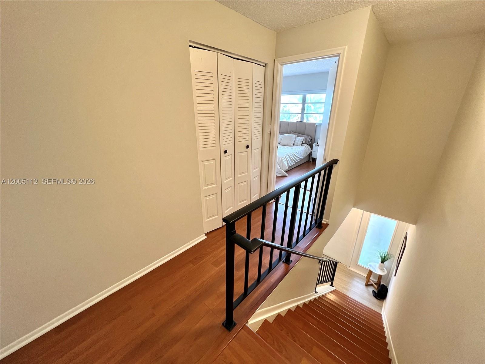 8114 Southwest 81st Terrace Miami, FL 33143 - Photo 17 of 20 a view of a hallway with wooden floor and stairs