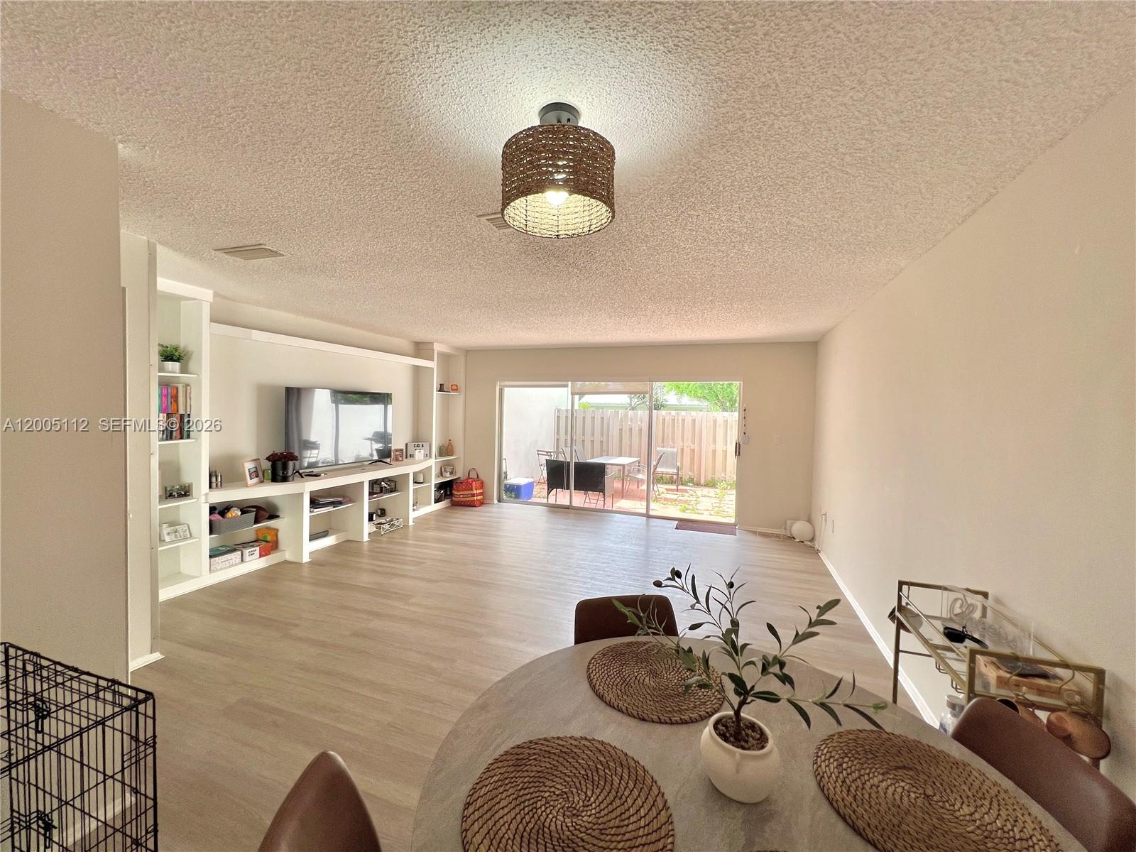 8114 Southwest 81st Terrace Miami, FL 33143 - Photo 2 of 20 a living room with furniture and a table