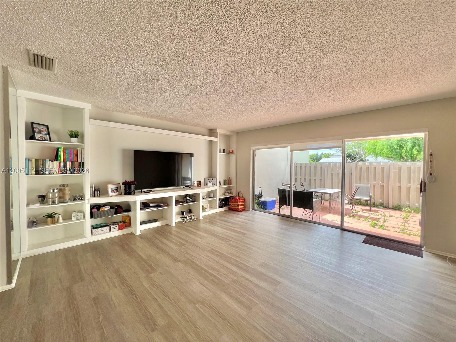 8114 Southwest 81st Terrace Miami, FL 33143 - Photo 4 of 20 a view of a livingroom with furniture and a flat screen tv