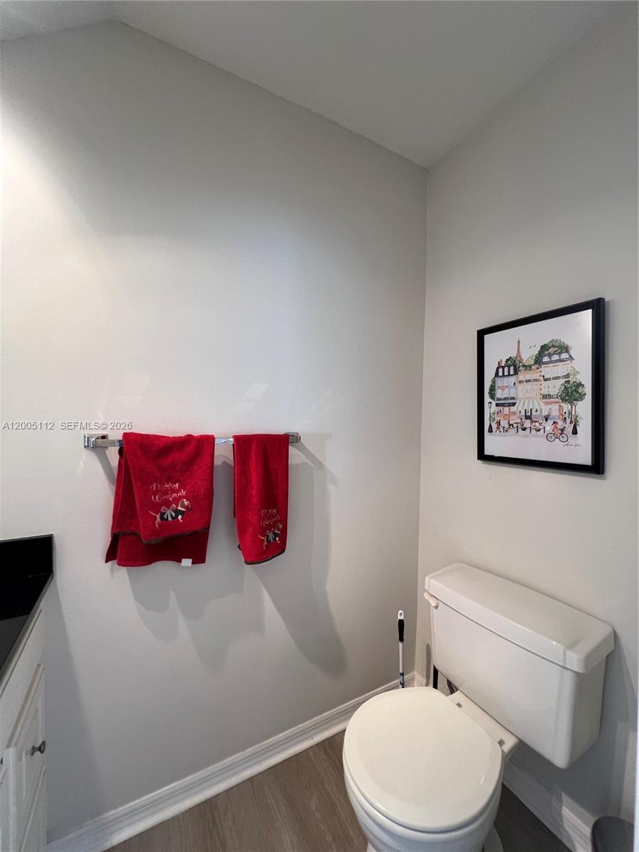 8114 Southwest 81st Terrace Miami, FL 33143 - Photo 5 of 20 a white toilet sitting next to a bathroom sink