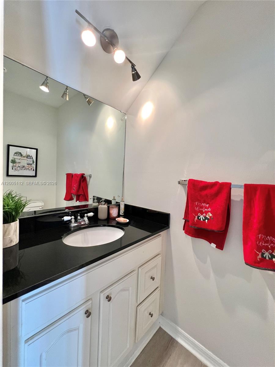 8114 Southwest 81st Terrace Miami, FL 33143 - Photo 6 of 20 a bathroom with a sink vanity and a mirror