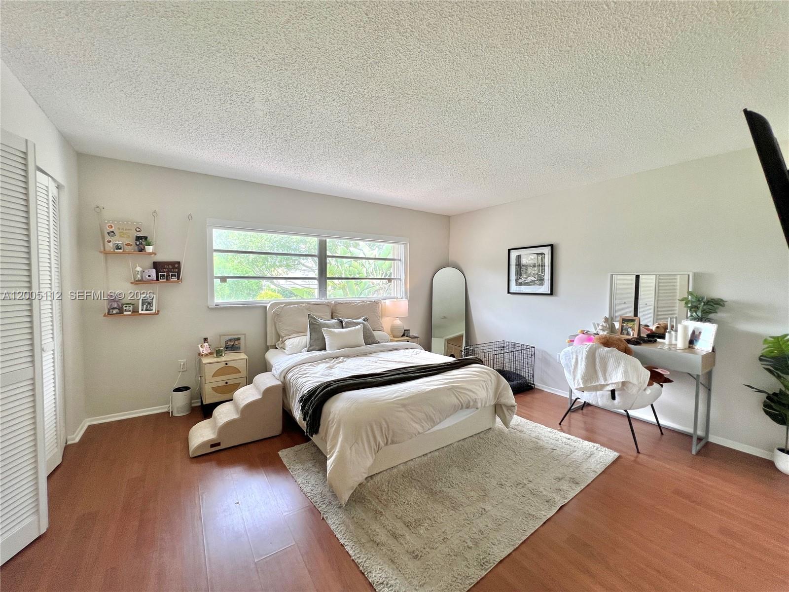 8114 Southwest 81st Terrace Miami, FL 33143 - Photo 10 of 20 a bedroom with two beds and wooden floor