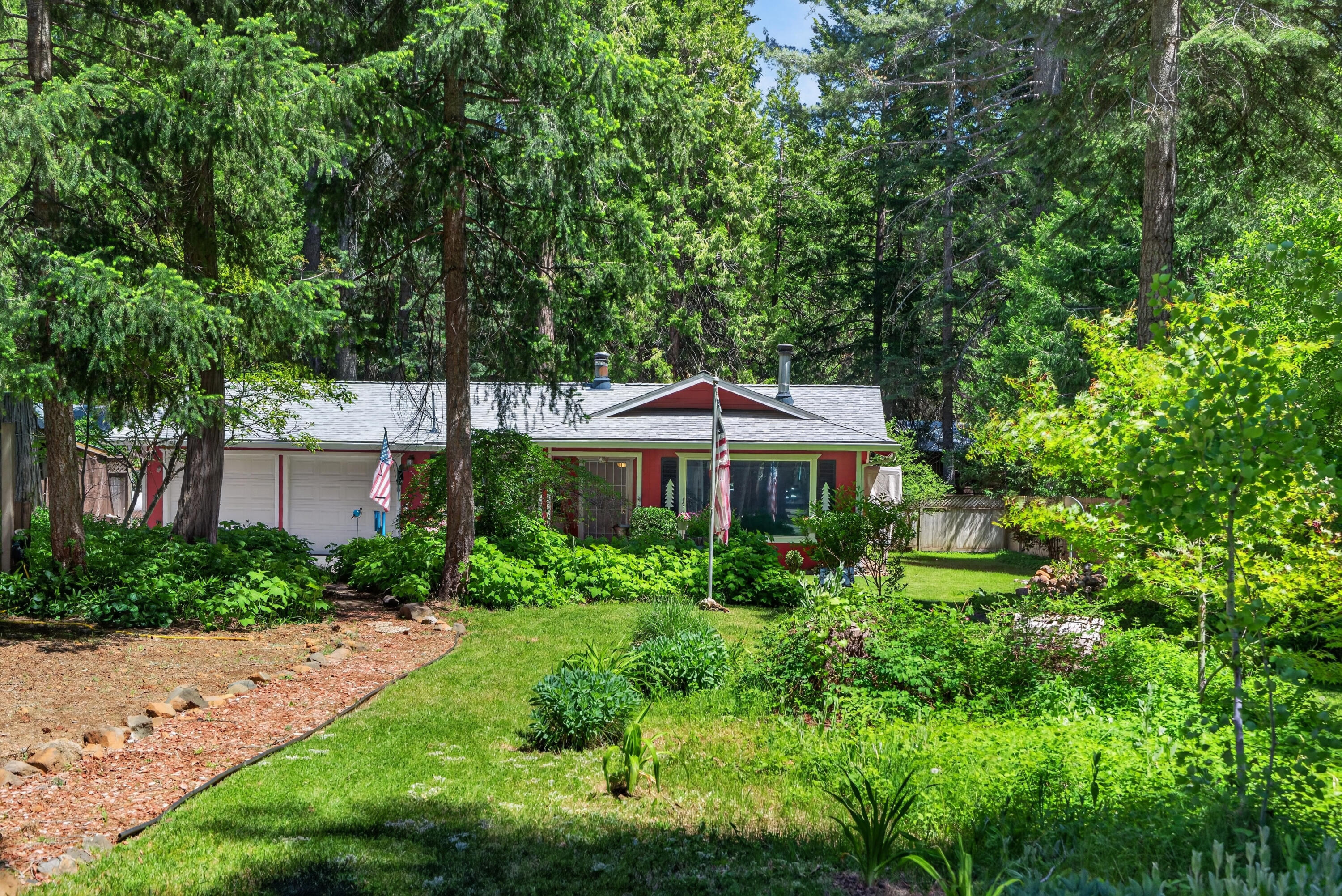 8015 Starlite Pines Road Shingletown, CA 96088 - Photo 4 of 38 a view of a garden in front of a house