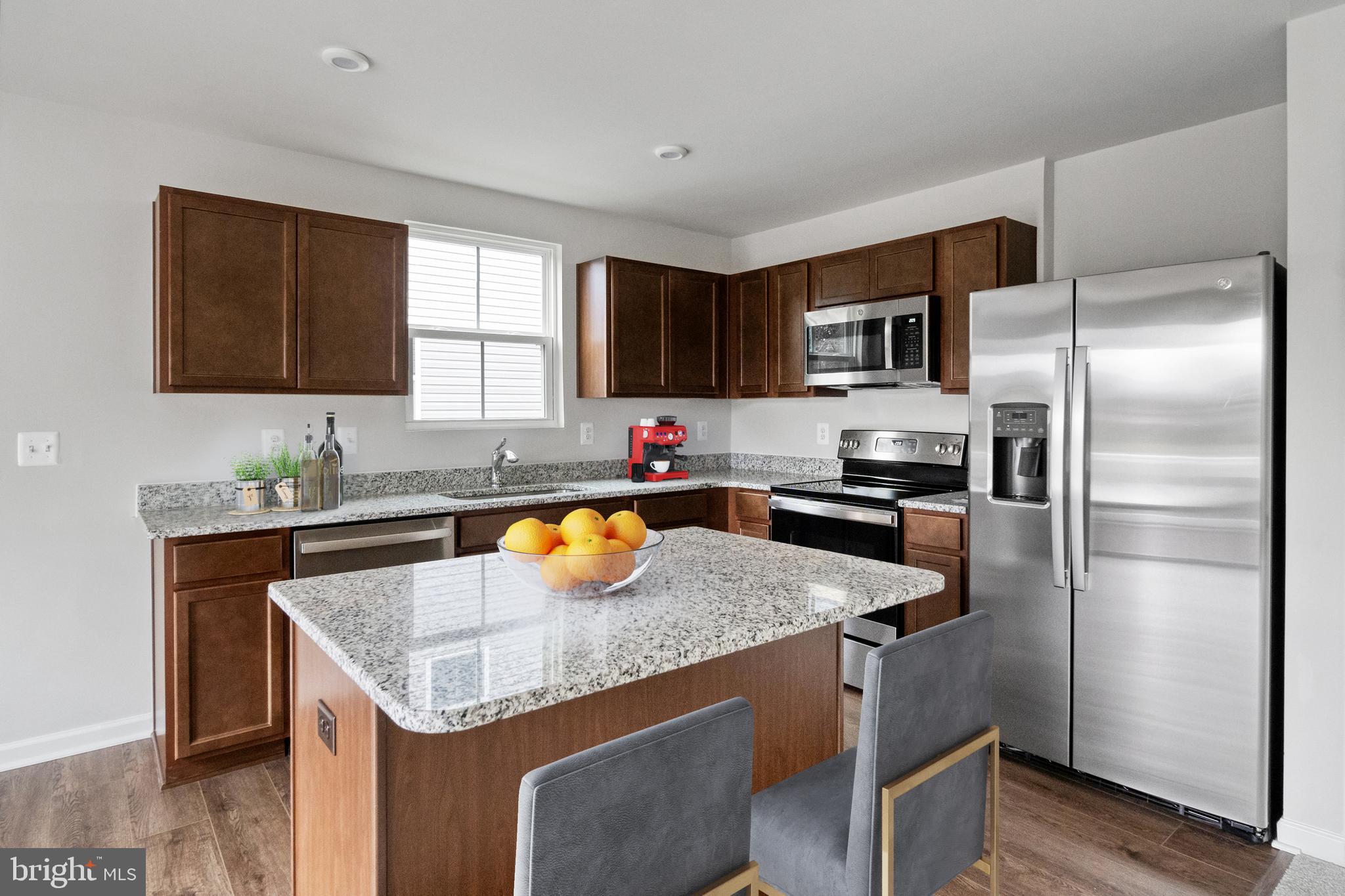417 Circle Drive Winchester, VA 22601 - Photo 8 of 33 a kitchen with a refrigerator a sink a stove and cabinets