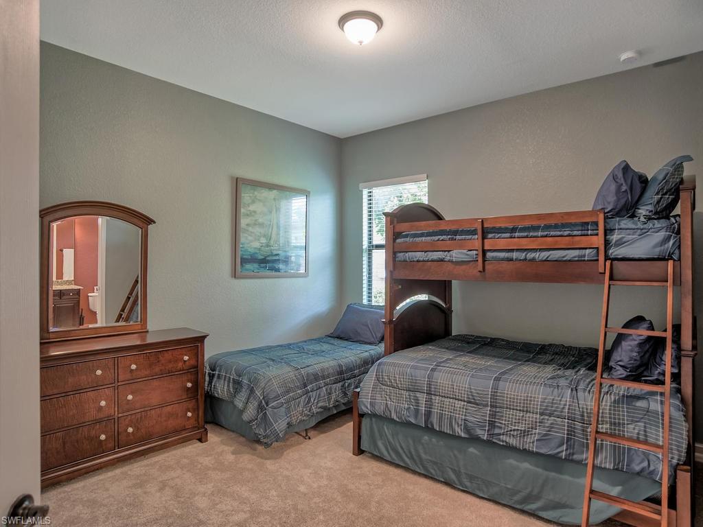 9634 Firenze Circle Naples, FL 34113 - Photo 20 of 35 a bedroom with a bed and cabinets