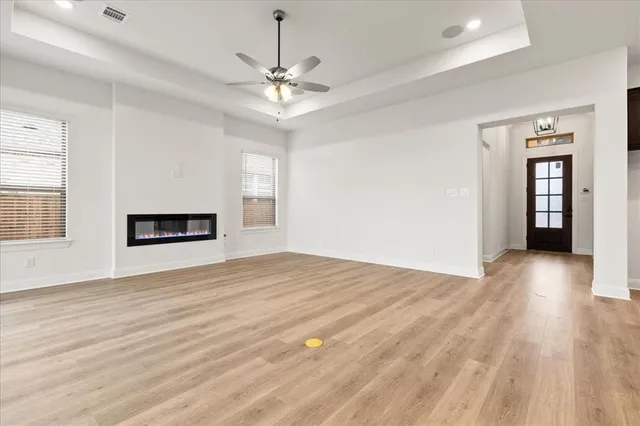 a view of empty room with wooden floor