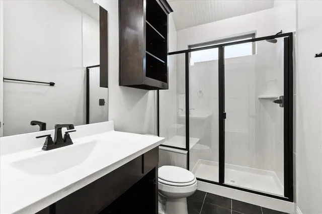 a bathroom with a sink toilet and mirror