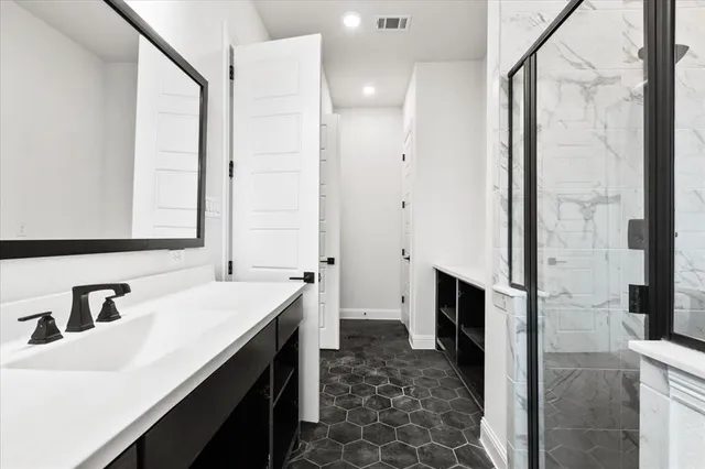 a spacious bathroom with a sink and a mirror