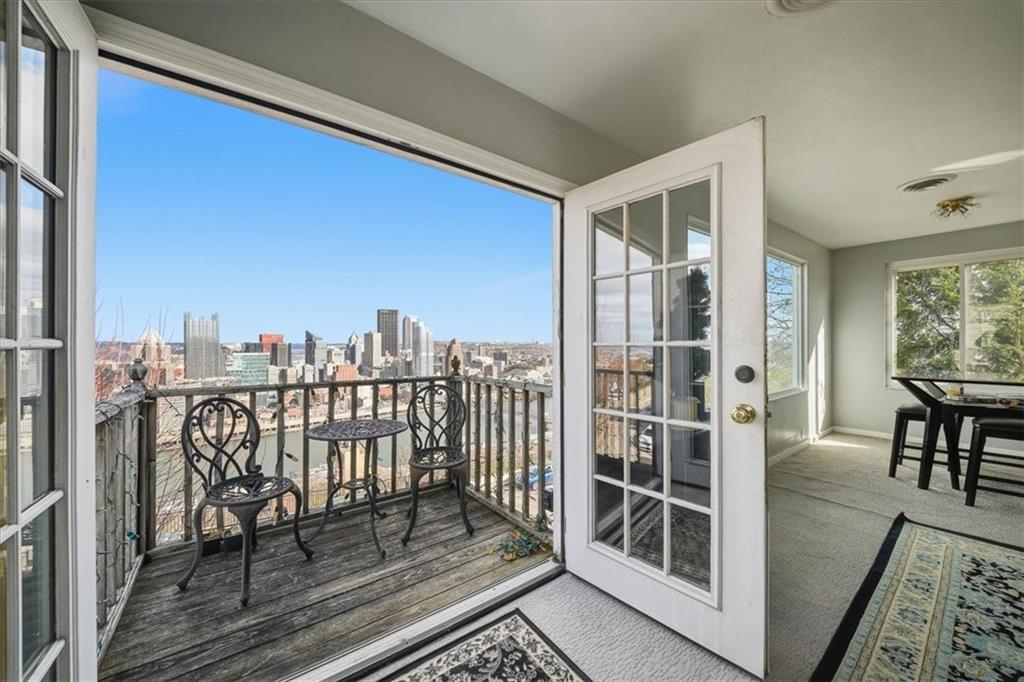 237 Grandview Avenue Pittsburgh, PA 15211 - Photo 30 of 43 a view of a balcony with furniture and a floor to ceiling window