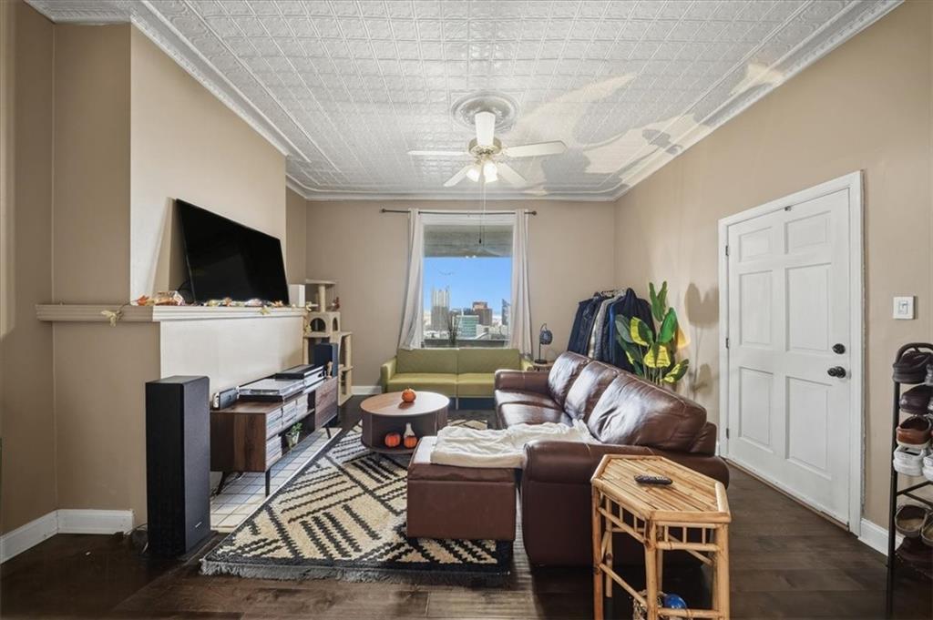 237 Grandview Avenue Pittsburgh, PA 15211 - Photo 4 of 43 a living room with furniture a window and a flat screen tv