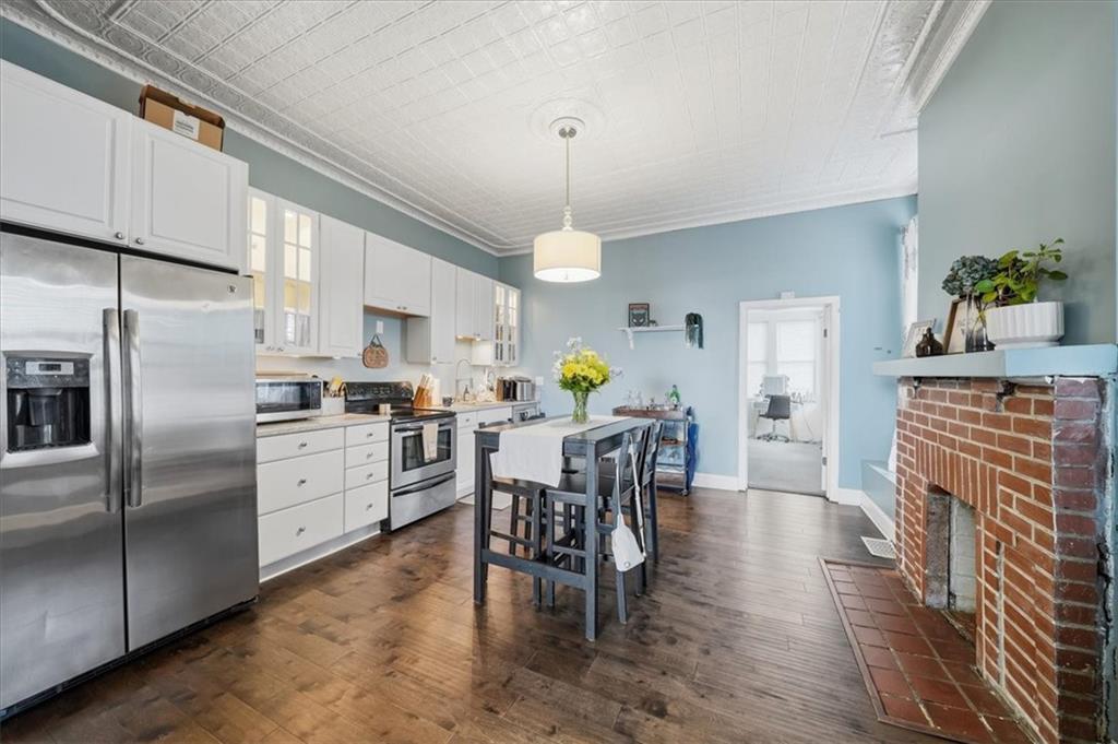 237 Grandview Avenue Pittsburgh, PA 15211 - Photo 6 of 43 a kitchen with refrigerator cabinets dining table and chairs
