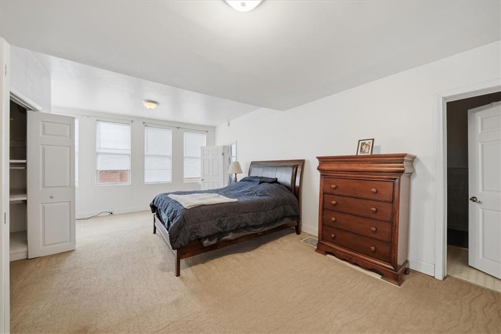 237 Grandview Avenue Pittsburgh, PA 15211 - Photo 9 of 43 a spacious bedroom with a bed and a window