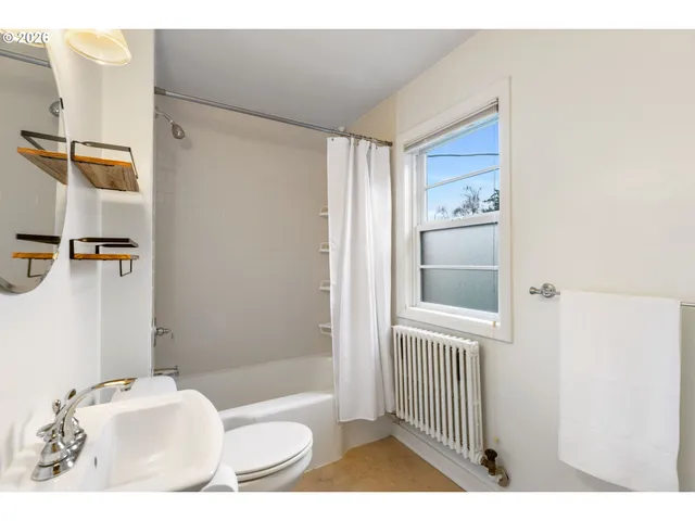 a bathroom with a bathtub and shower