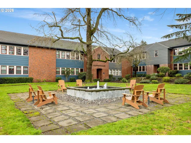 a view of a house with swimming pool and sitting area