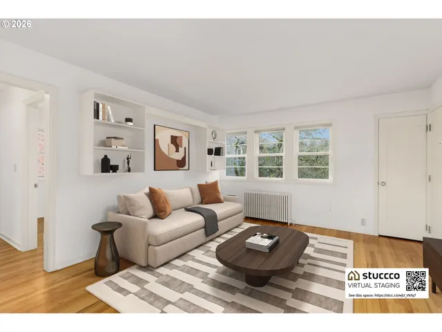 a living room with furniture and a window with wooden floor