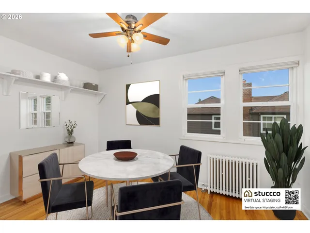 a living room with furniture a flat screen tv and a table