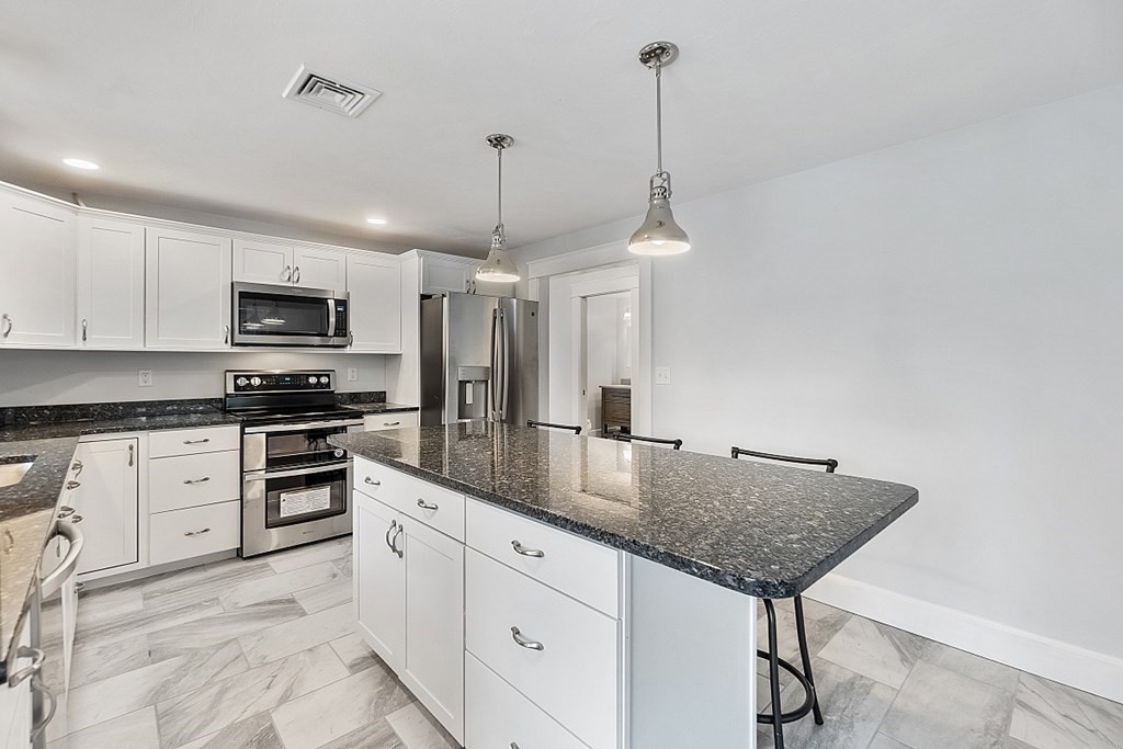 37 Watatic Pond Road Ashburnham, MA 01430 - Photo 8 of 42 a kitchen with stainless steel appliances granite countertop a stove a sink and a refrigerator
